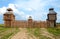 Photo of fort with wooden stockade and four towers.