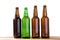 Photo of four different full beer bottles with no labels. Separate clipping path for each bottle included. Four 4 separate photos