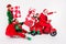 Photo of four excited people ride moped sleigh deliver bag wear santa elf costume isolated white color background