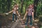 Photo of four people couple happy positive smile have fin piggyback forest trees nature hiking expedition outdoors