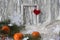 Photo frame with a red heart, bright tangerines with festive tinsel , side view - the concept of wonderful memories of the