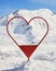 Photo frame shaped like a red heart in Val d\\\'Isere ski resort, France, in Winter.