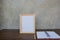 Photo Frame on a wooden table and book on Gray wall background .