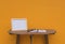 Photo Frame on a wooden table and book and Yellow background .