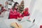 Photo of freelancer lady sit workspace typing keyboard wear santa hat sweater in decorated x-mas home indoors