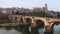 Photo of French city Albi and river Tarn with view of cathedral along riverside.