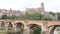 Photo of French city Albi and river Tarn with view of cathedral along riverside.