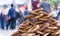 Photo of fresh bagels, buns on street. Traditional turkish street food. Simit for sale from Street vendor. Blurred people in