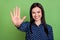 Photo of friendly charming girl showing high-five gesture wear dotted blouse isolated on green color background