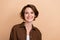 Photo of friendly gorgeous pleasant woman with bob hairstyle dressed brown shirt toothy smiling isolated on beige color