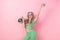 Photo of friendly woman with ponytails wear wavy blouse in blue sunglass hold discoball waving palm isolated on pink