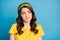 Photo of frustrated girl look empty space think feel sorry wear yellow polka-dot clothes isolated over blue color