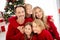 Photo of full big family five people gathering three little kids embrace cuddle sit floor shiny smiling wear red jumper