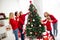 Photo of full big family five people meeting three little kids dad hold daughter sister help brother decorate x-mas tree