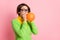 Photo of funky amazed woman blow air balloon wear glasses green shirt isolated on pastel pink color background