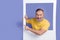 Photo of funky cheerful retired man dressed striped t-shirt hold frame directing at promo empty space isolated on purple