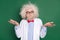 Photo of funky funny crazy scientist in glasses messy hair shrug shoulders doubtful isolated on green color background