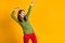 Photo of funky youngster lady dance disco hit party wear green pullover red trousers isolated yellow color background