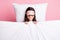 Photo of funny adorable young lady nightwear mask covering blanket lying pillow isolated pink color background