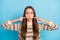 Photo of funny childish young lady wear ornament sweater pointing fingers cheeks looking nose isolated blue color