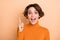 Photo of funny clever young lady wear orange turtleneck having idea pointing finger  beige color background