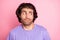 Photo of funny clueless guy look empty space wear violet shirt isolated pastel pink color background