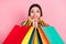 Photo of funny customer shopaholic lady hold store packages hands cheek wear sweater isolated pink color background