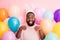 Photo of funny dark skin guy colorful decorations easter party hold arms like rabbit paws obedient person wear sweater