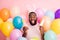 Photo of funny dark skin guy colorful decorations easter party hold two pretty ginger bread cookies wear sweater bunny