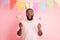 Photo of funny dark skin guy visit family easter party hold festive colorful painted eggs on sticks wear sweater pants