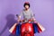Photo of funny driver woman wear striped outfit red helmet sitting bike looking empty space  purple color