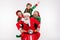 Photo of funny funky four people teammates ride motorbike party wear santa elf costume isolated white color background