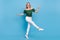 Photo of funny funky lady dance wear bear shoulders green blouse pants footwear isolated blue color background