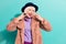 Photo of funny funky senior lady wear arms retro jacket headwear showing v-sign isolated teal color background