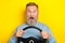 Photo of funny impressed retired guy wear blue sweater driving automobile open mouth isolated yellow color background