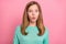 Photo of funny impressed schoolgirl wear turquoise sweater big eyes isolated pink color background