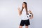 Photo of funny lady direct finger side empty space advising watch soccer match sports bar pub hold leather ball wear