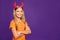 Photo of funny little lady with long hair and horns headband playing helloween party satan devil character crossed arms