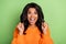 Photo of funny lucky dark skin lady dressed knitted pullover rising fists isolated green color background