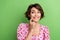 Photo of funny pleasant woman dressed pink blouse finger on teeth look at dental ad empty space isolated on green color
