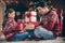 Photo of funny positive cheerful relatives play game clap hands wear sweater in decorated x-mas apartment indoors