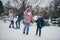 Photo of funny positive little child wife husband dressed coats dancing enjoying cold weather together outdoors urban