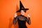 Photo of funny scary girl dressed black gothic dress headwear ready catch you isolated orange color background