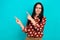 Photo of funny strict beautiful young lady wear dotted trendy red shirt direct fingers look mockup unsure isolated on