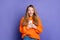 Photo of funny teen girl brown hair dressed orange knitted jumper bought her first brand new smartphone isolated on