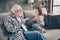 Photo of funny two people old grandpa little granddaughter sitting comfort sofa telling good story stay house quarantine