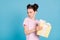 Photo of furious unhappy school girl wear pink t-shirt holding yellow present box looking empty space isolated blue