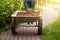 Photo of garden wheelbarrow with earth at sunny day