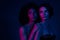 Photo of gentle ladies touch look empty space enjoy dj in futuristic modern discotheque with ultraviolet neon light
