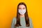 Photo of girl standing in front of camera and trying not to blink keep social distance wear medical mask isolated with